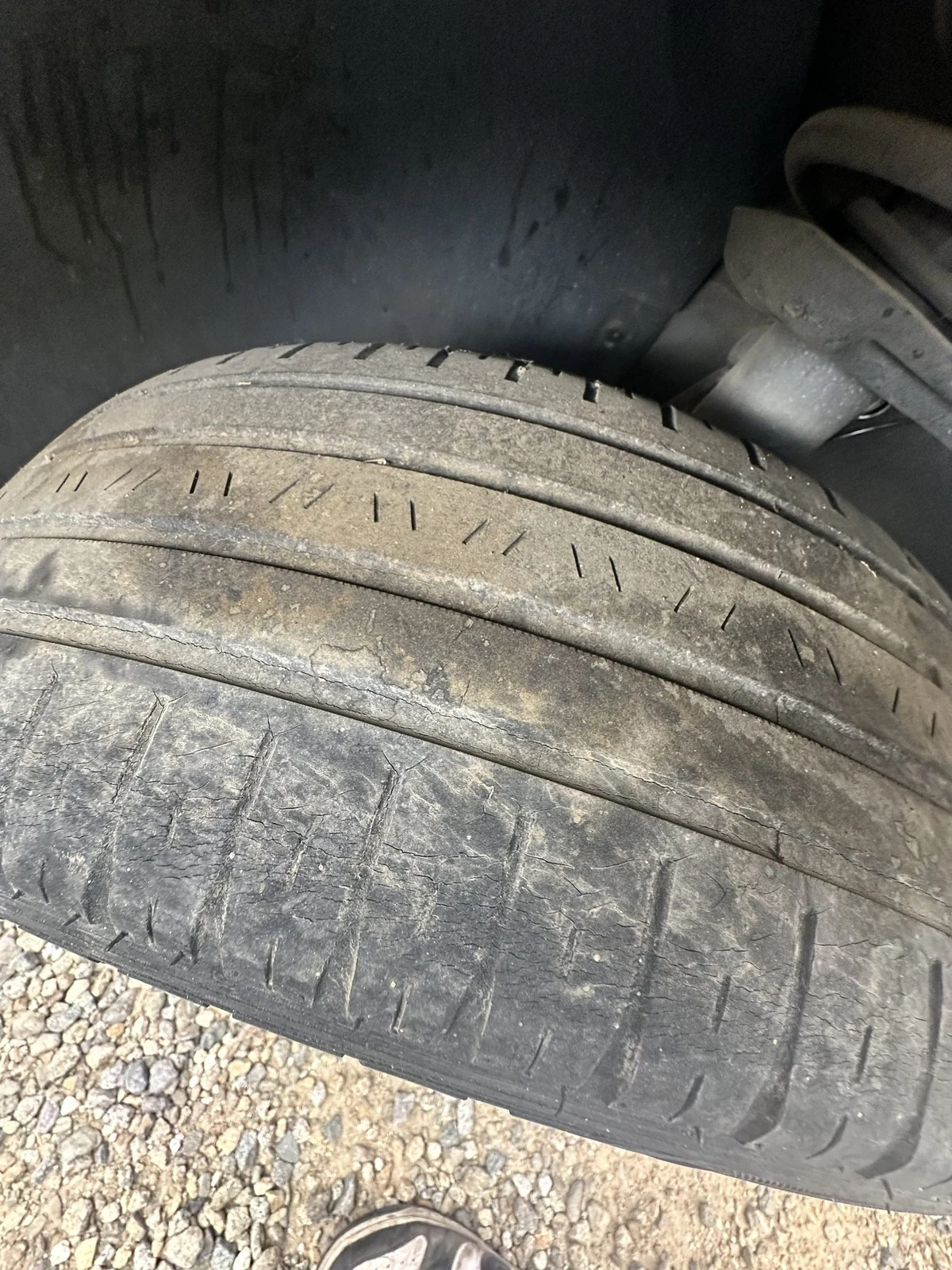 A car tire with tread worn almost flat